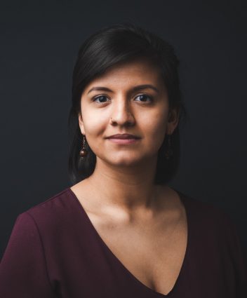 Headshot of Shanti Gonzales, with a dark background